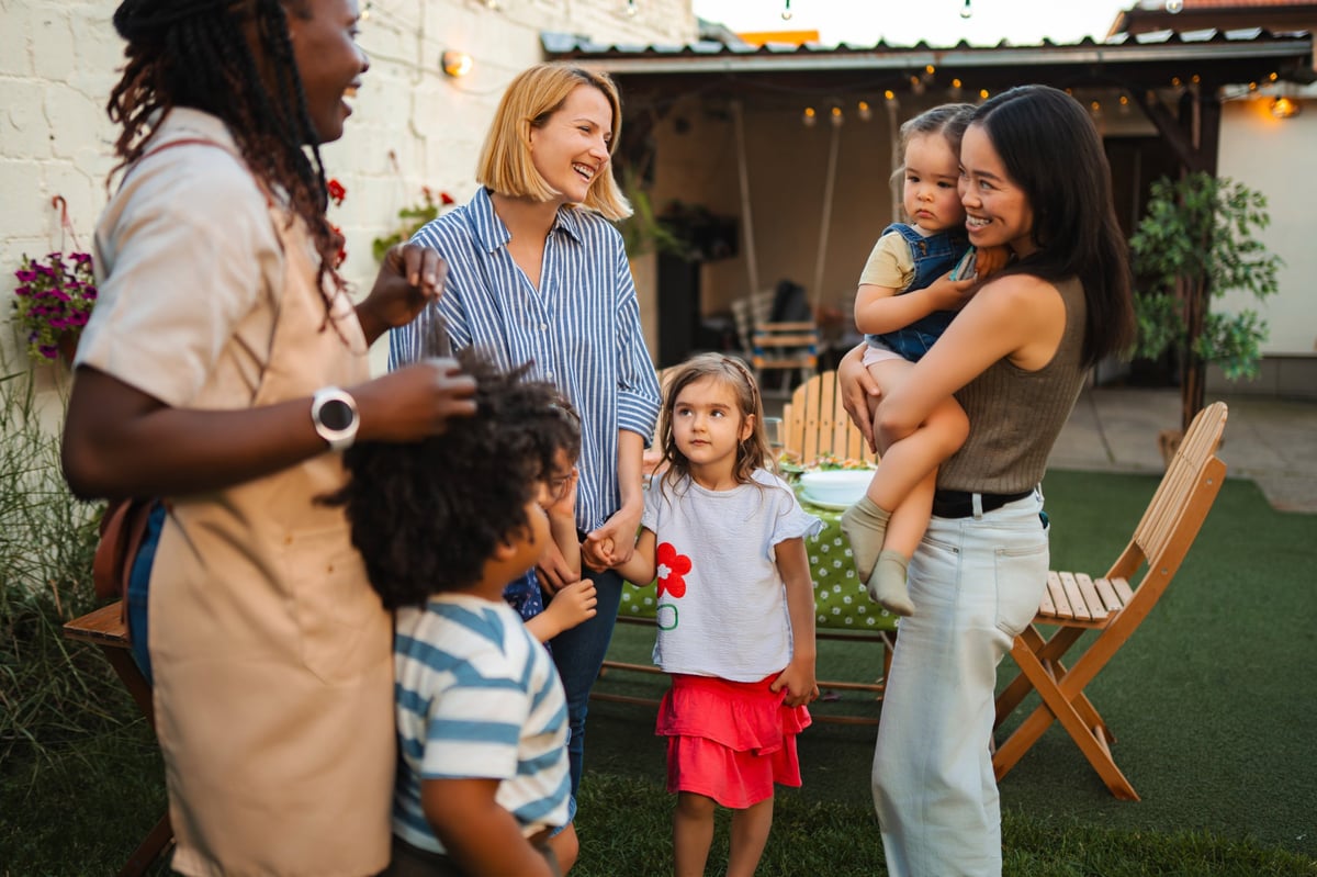 Happy families socializing together during a relaxed summer gathering in the garden