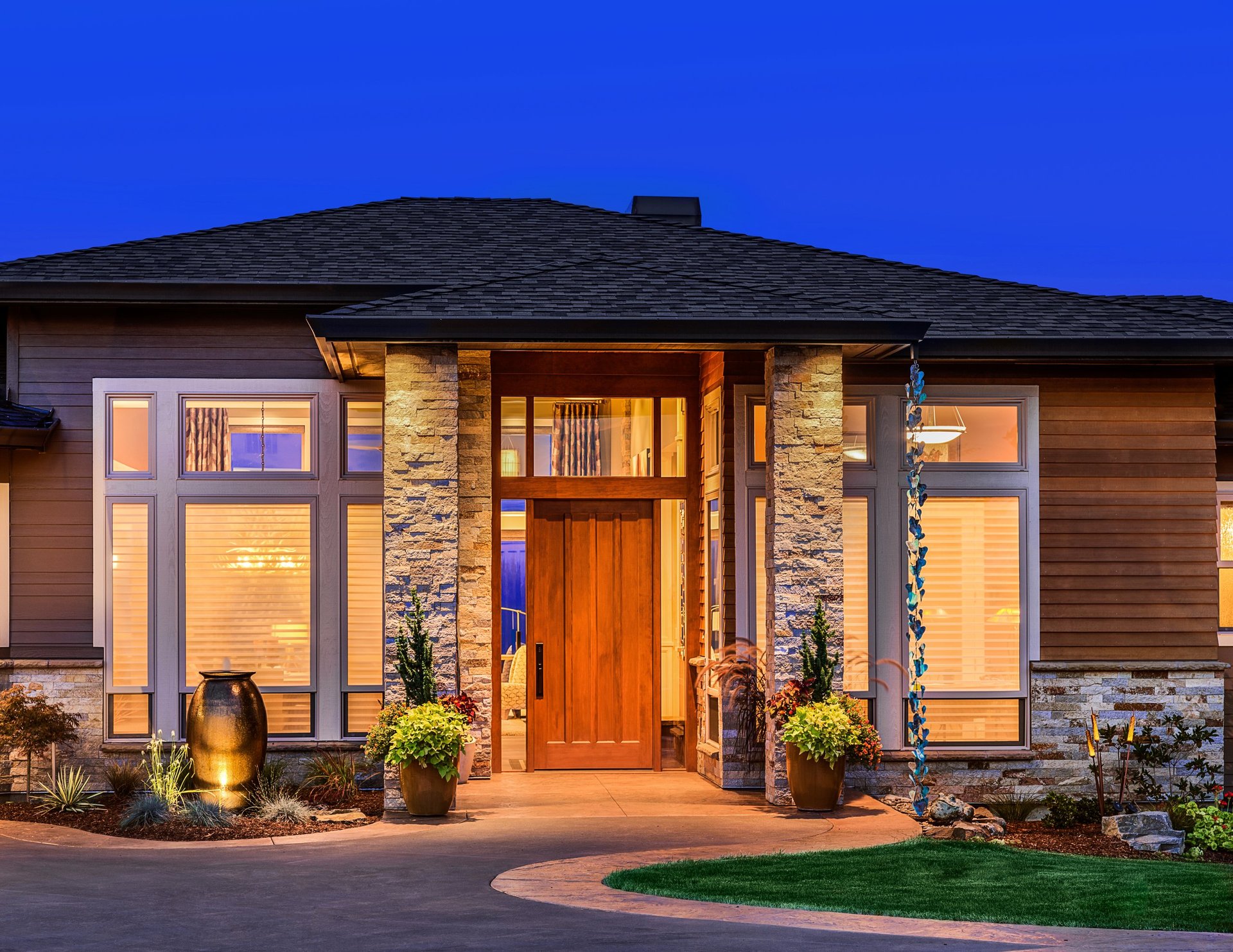 Front elevation of luxury home in evening with deep blue sky