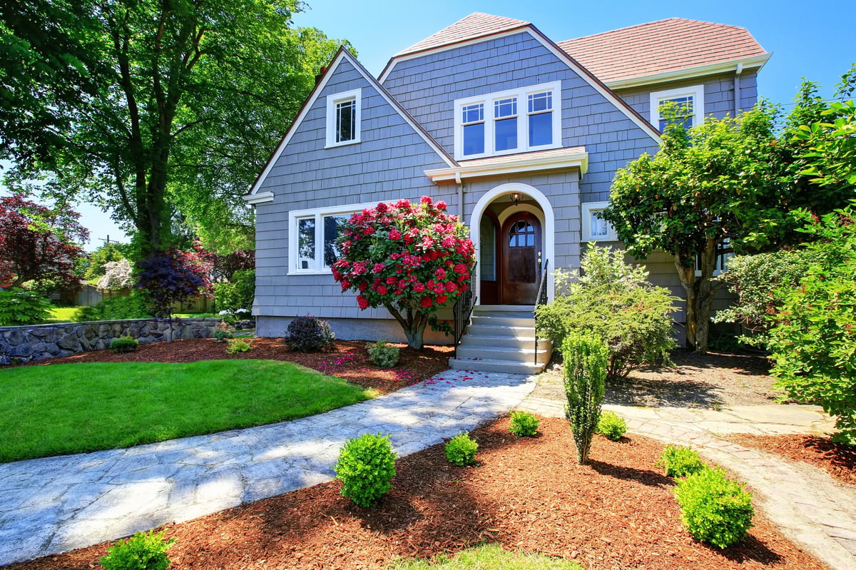 American craftsman house exterior. View of entry door and porch with concrete stairs. Nice landscape design around. Northwest, USA