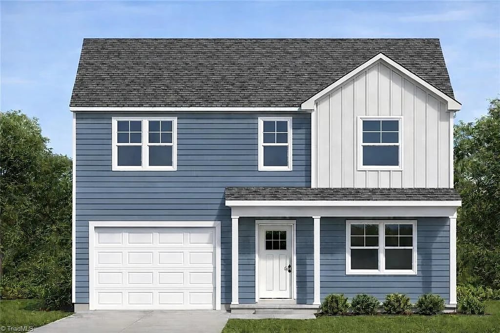 Two-story blue and white house with white garage, front porch, and pitched roof against clear sky